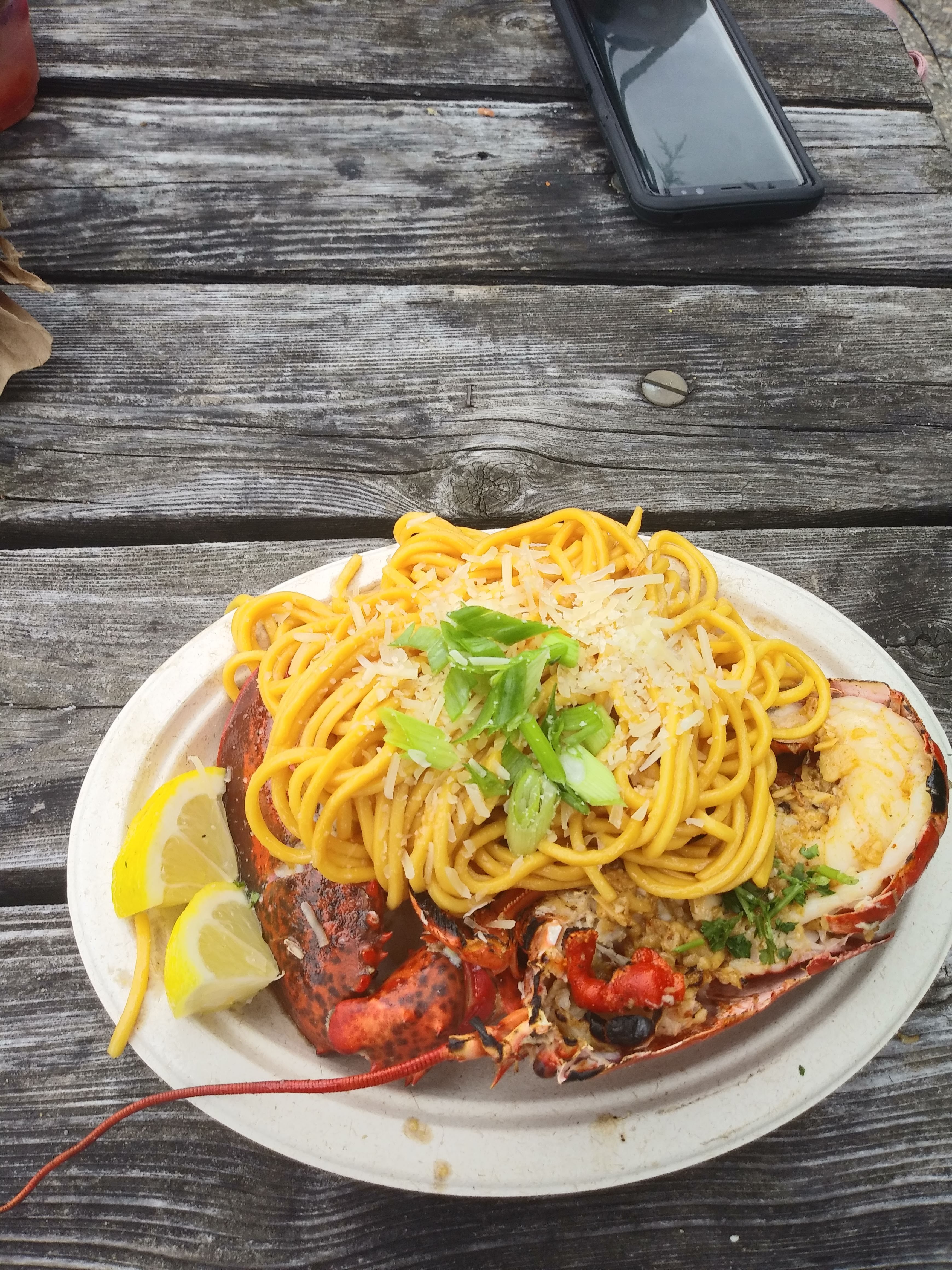 Plate of pasta and lobster for how to spend a sustinble day in NYC